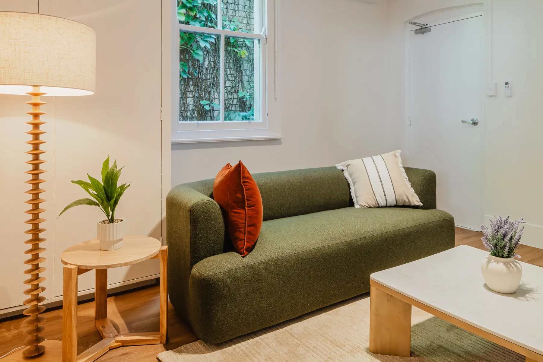 The green-sofa living room at Sareh Balmain